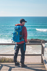 Tourist enjoys the view from a viewpoint on a sandy beach on the Atlantic coast near Vila Nova de Milfontes, Odemira, Portugal. Following in the footsteps of the Rota Vicentina. Fishing Trail