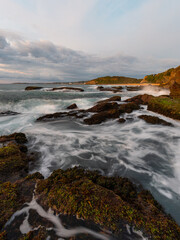 Beautiful water flow around the rocky coastline.