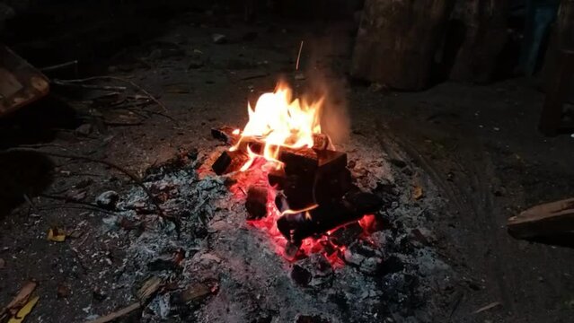Camp fire burning outside at night. Burning and sparking campfire at night with burning woods. soothing beautiful footage. Bonfire, fire energy background