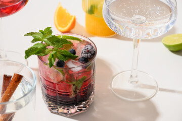 Blackberry mojito with lime on white background for festive party. Summer freshness beverage. Close up.