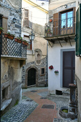 Fototapeta na wymiar A narrow street among the old houses of Pofi, a medieval town in the Lazio state, province of Frosinone in Italy.