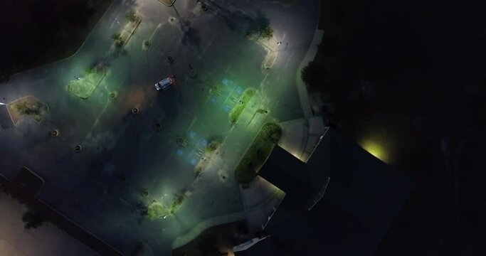 Aerial Top Panning Shot Of Car In Parking Lot Outside House At Night - New Orleans, Louisiana