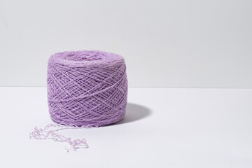 A skein of purple knitting threads on a gray isolated background. Handicraft, small business and hobby concept. Image for your design