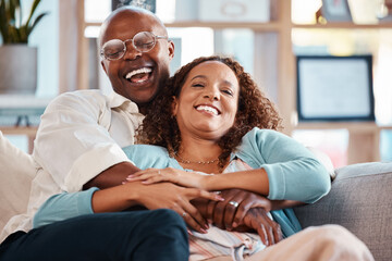 Couple, hug and laughing on sofa portrait in home living room, bonding and having fun. Interracial,...