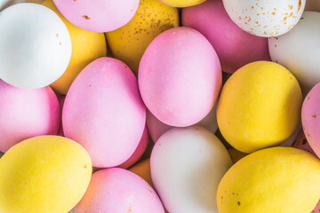 Fototapeta na wymiar Colored sweet little eggs. Multi-colored Easter eggs on a plate.