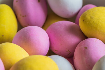 Colored sweet little eggs. Multi-colored Easter eggs on a plate.