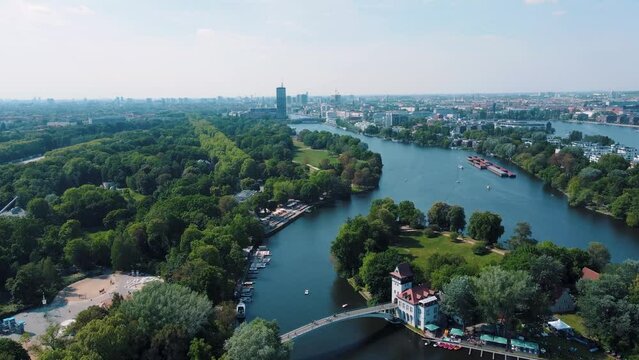 Aerial drone view of boats in the Spree River near Spreepark Planterwald and Treptower Park Berlin