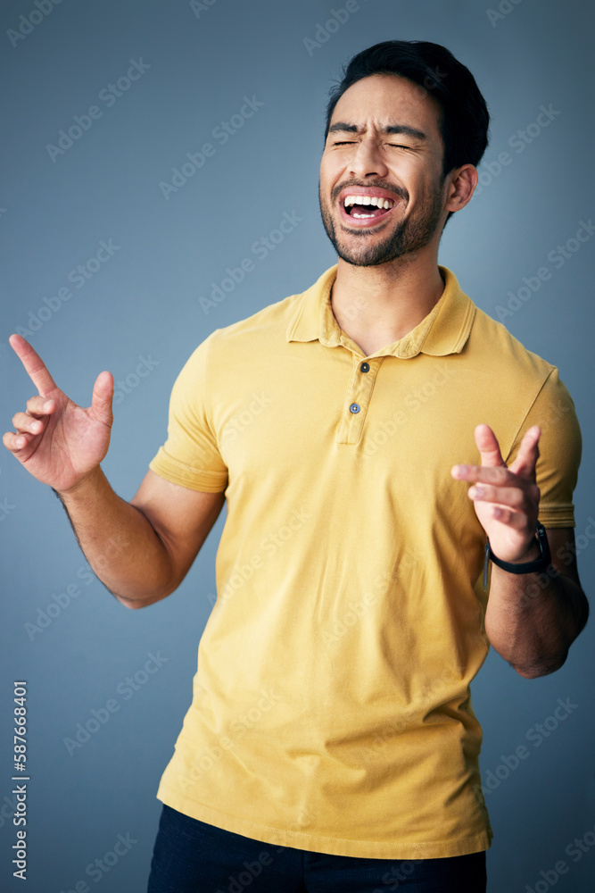 Aufkleber karaoke, happy and a singing asian man with a song isolated on a grey background in a studio. smile,