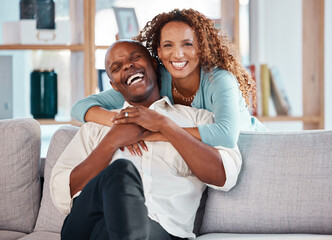 Couple, hug and laughing on sofa portrait in home living room, bonding and having fun. Interracial,...