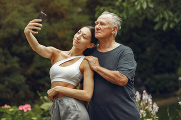 Portrait of happy handsome older man using smartphone