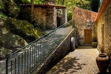 Old restored stone house with rustic stone facade of watermill Moinho do Poucochinho in the...