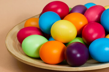 Lots of dyed eggs on a brown background. Happy Easter