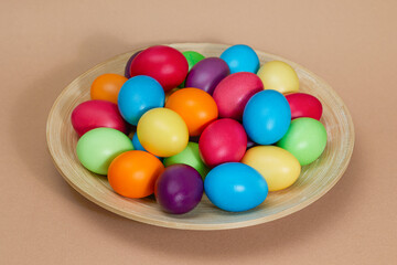 Lots of dyed eggs on a brown background. Happy Easter