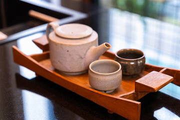 Fototapeta na wymiar japanese green tea cup traditional, Green tea accessories on tray on wooden table. Japanese tea ceremony concept.