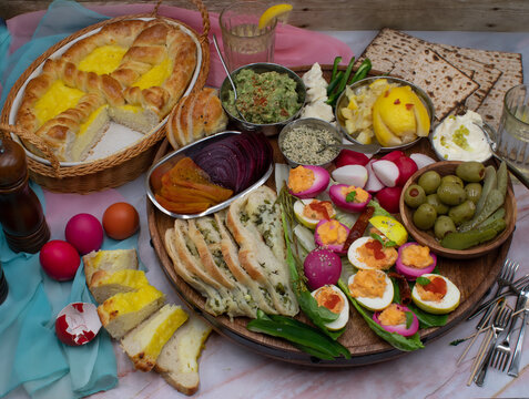 Easter brunch tray consisting of Eastern European pasca bread, deviled eggs, pickles, spreads and cudites