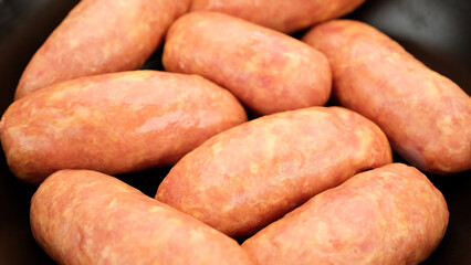 Sausages. Uncooked sausages preparation for grilling