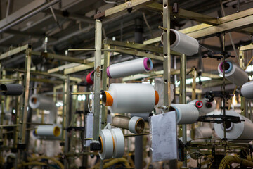Fototapeta na wymiar Textile industry with knitting machines in factory. Textile industry with a loom on the production of kapron tights.