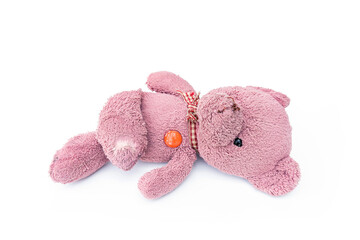A broken and shabby old pink teddy bear isolated on white background.