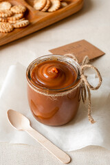 Homemade salted caramel sauce in glass jar