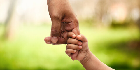 Closeup rear view of mother and a child hands holding together. Mother and child relation. Family time, vacation, weekend concept.