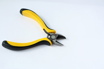 Obraz premium Yellow side cutters on a white background. Side cutting tool. Selective focus.