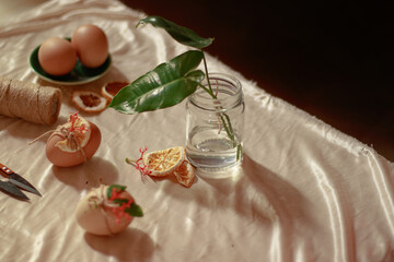 Handmade rustic earth day themed easter egg design using zero waste material like twines flowers and dried lemons