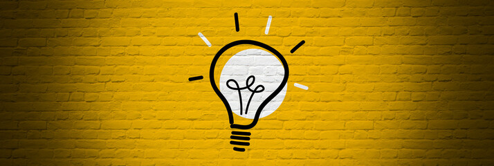 Light bulb on yellow bricks background
