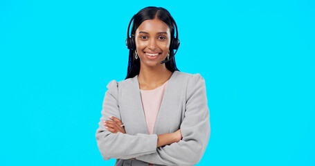 Call center, portrait or Indian woman in studio for communication isolated on blue background. Face...