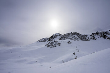 snow covered mountains in hazy evening light