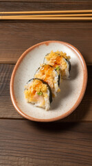A Plate  with Shrimp Tempura  Rolls in a Rustic Setting