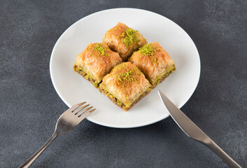 Pistachio Turkish baklava on a white plate.Traditional delicious Turkish baklava
