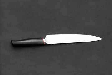 Large kitchen knife on a black background