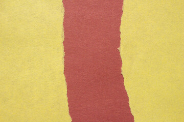 Fototapeta premium Yellow torn paper on a red background