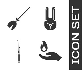 Set Hand holding a fire, Witches broom, Magic wand and Rabbit with ears icon. Vector