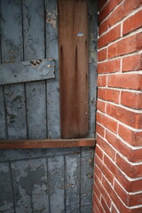 aged blue wooden door with red bricks wall design for traditional interior style