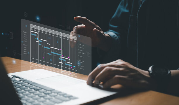 Business people with suit using digital tablet to access into data and dashboard that show implementation and working timeline of product launch or business strategy and planning