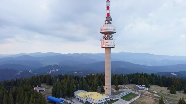 Tower Snezhana on peak of Snezhana covered with spruce forests in Rhodope mountains