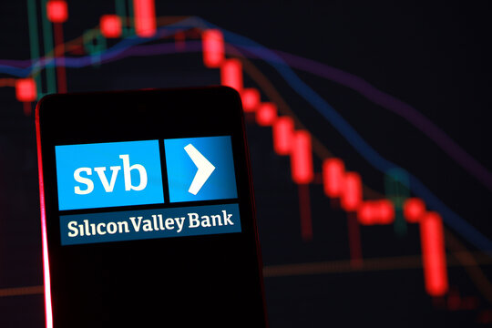 PENANG, MALAYSIA - 1 APR 2023: Silicon Valley Bank logo with stock market chart. The bank was shut down after its investments greatly decreased in value and depositors withdrew large amounts of money.