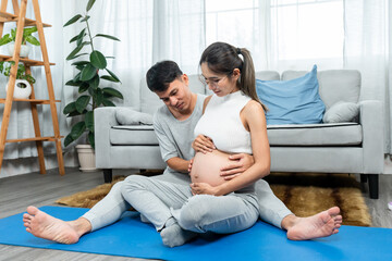Beautiful Asian mom, sitting with she husband, two them sat looked at belly growing, two pairs of...