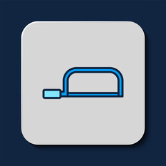 Filled outline Hacksaw icon isolated on blue background. Metal saw for wood and metal. Vector