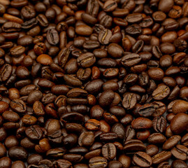 Espresso roasted coffee beans isolated in black background close up