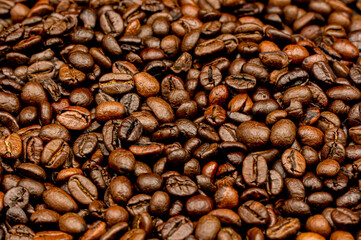 Espresso roasted coffee beans isolated in black background close up