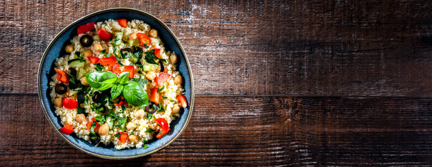 A plate of couscous served with vegetables and chickpeas