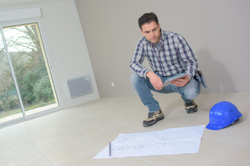 engineer checking plans construction site