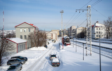 Railroad station. An old steam locomotive on a siding. City of Murmansk. Russia March 2023