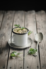 Vegetable soup in an enamel cup
