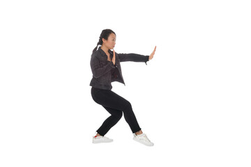 Asian young woman doing martial arts in everyday casual street clothing