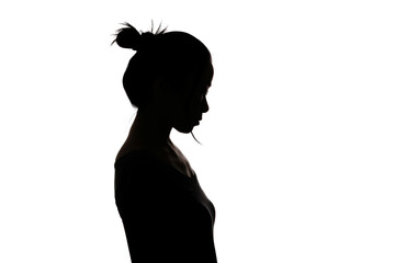 Black backlit silhouette of head and shoulders of an oriental woman from the side outlined by light