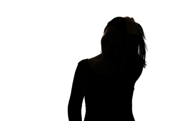 Black backlit silhouette of head and shoulders of an oriental woman from front view outlined by...