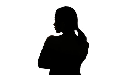 Black backlit silhouette of head and shoulders of an oriental woman from back view outlined by light